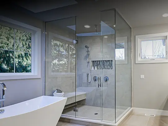 Frameless glass shower enclosure installation in a modern bathroom