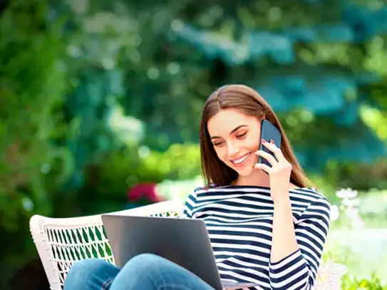 Woman contacting pool and spa company while browsing on a laptop