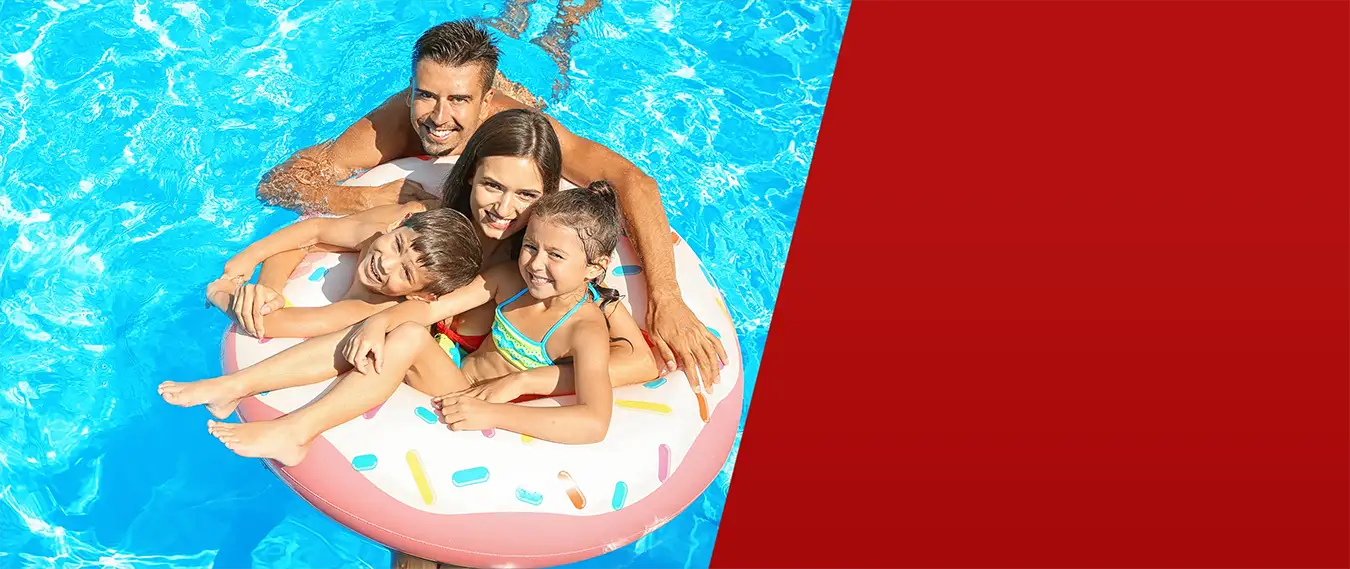 Happy family enjoying inflatable raft on above ground pool during summer