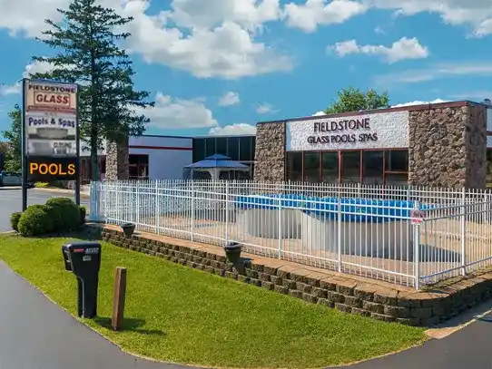 Fieldstone Glass Pools & Spas storefront displaying above ground pools and hot tubs for sale