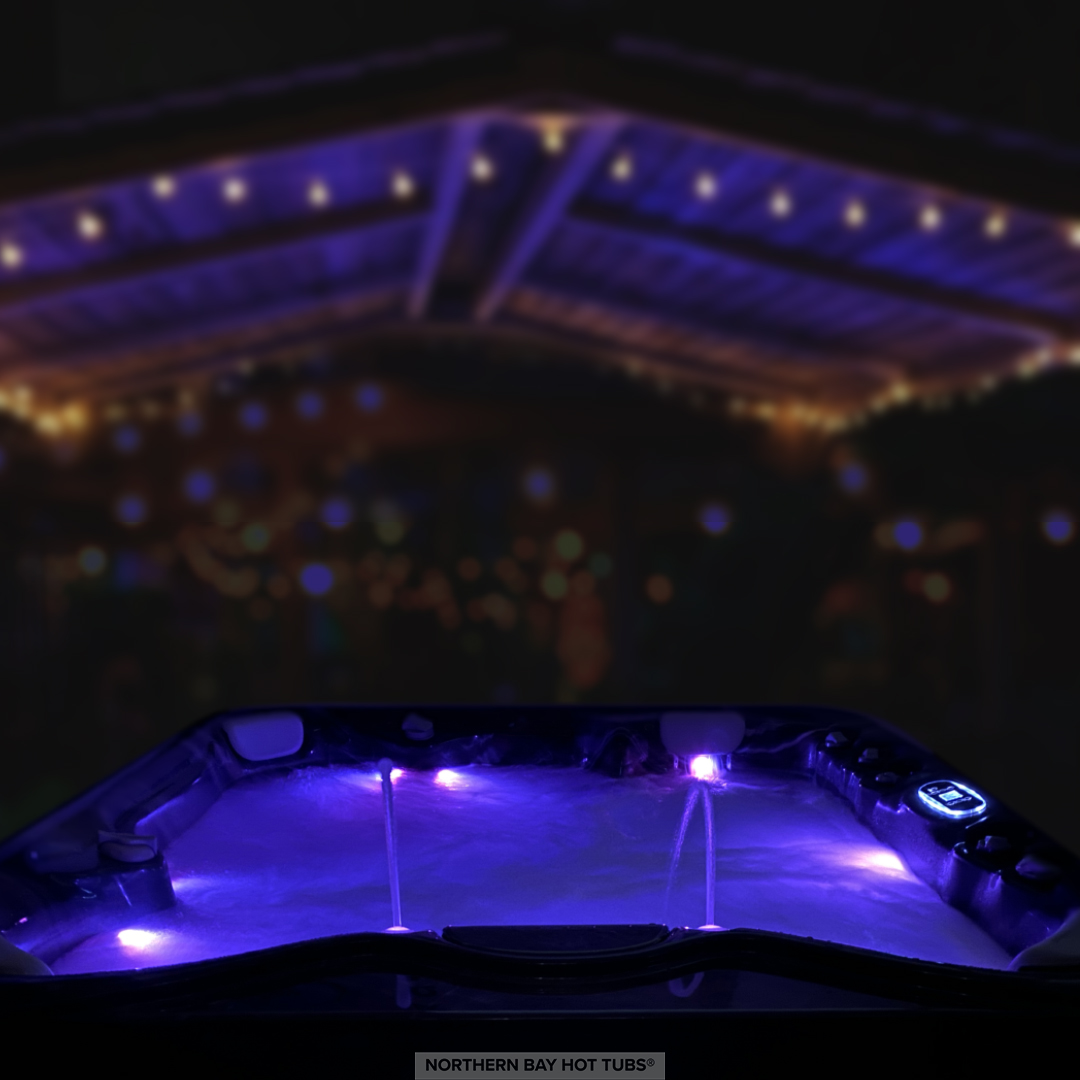 Illuminated hot tub with blue LED lighting at nighttime event venue