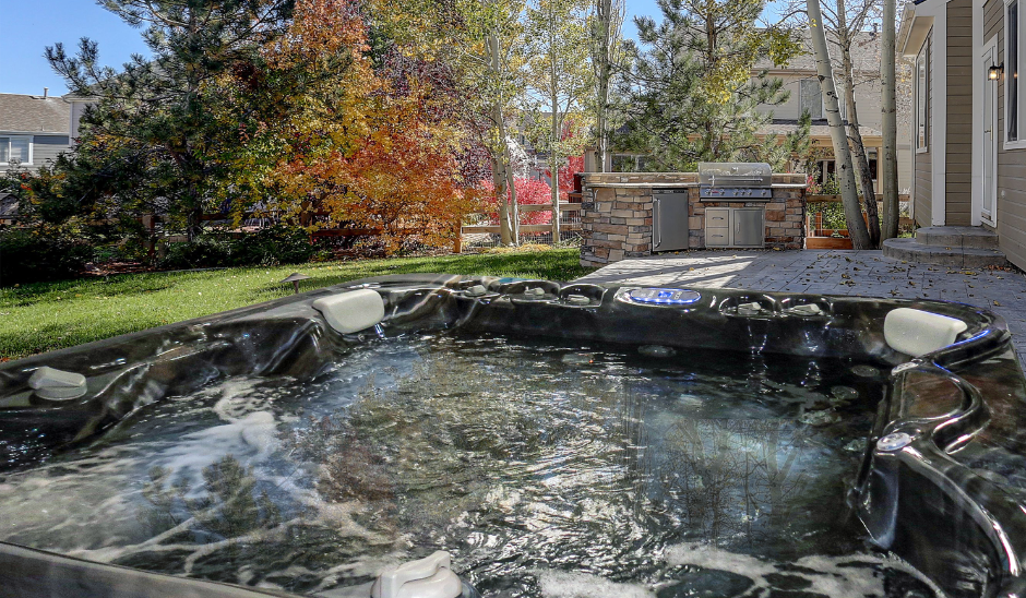 Luxurious backyard hot tub installation with jets and seating in residential patio setting