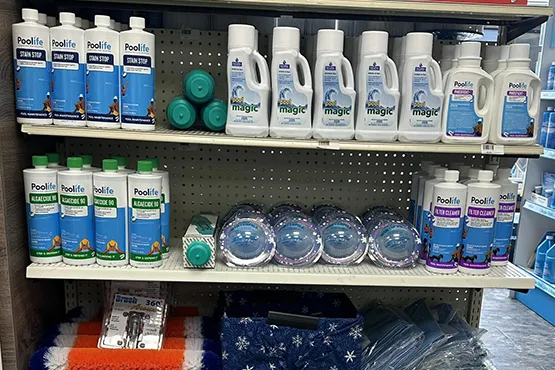 Pool maintenance supplies and accessories displayed on retail shelves at Fieldstone Glass, Pool & Spas