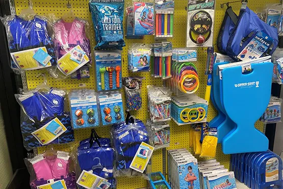 Pool accessories and supplies display including floats, games, and maintenance products