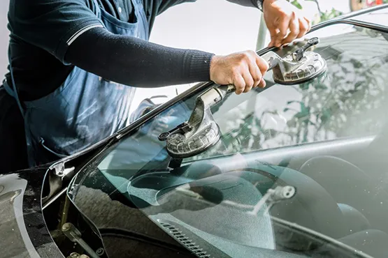 Technician installing wiper blades on car windshield for pool maintenance service